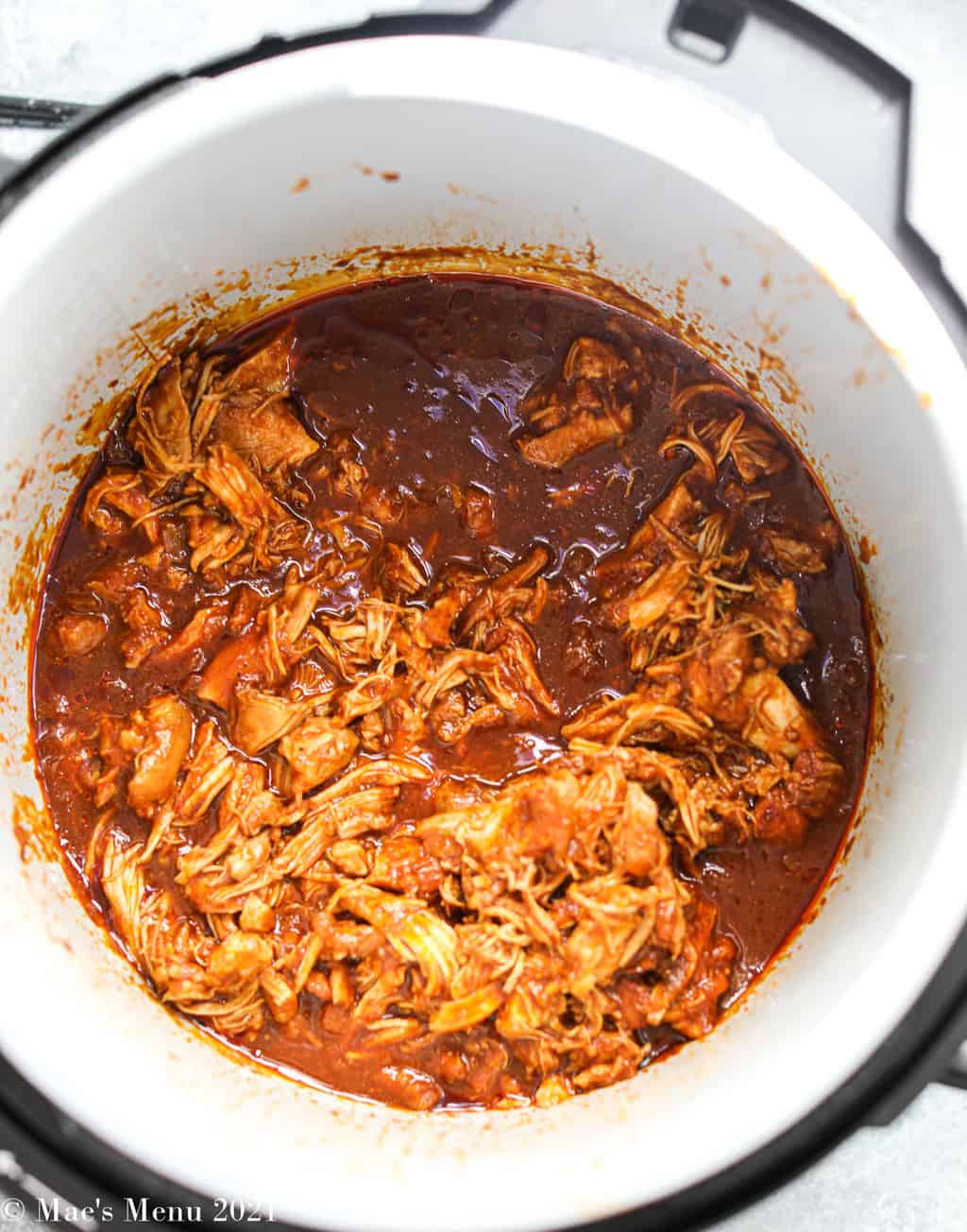 Shredded chicken in barbecue sauce in the instant pot bowl 