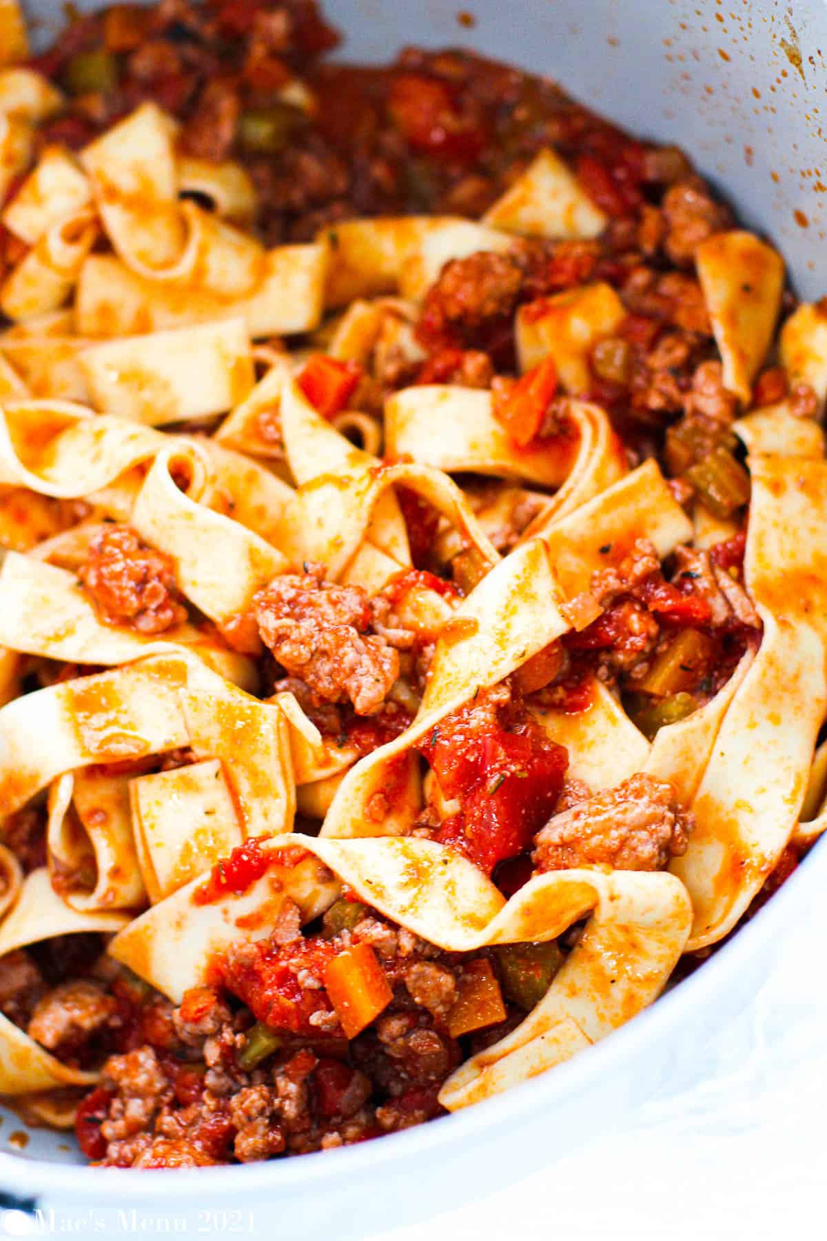 Chicken bolognese tossed with pappardelle in a large pot 