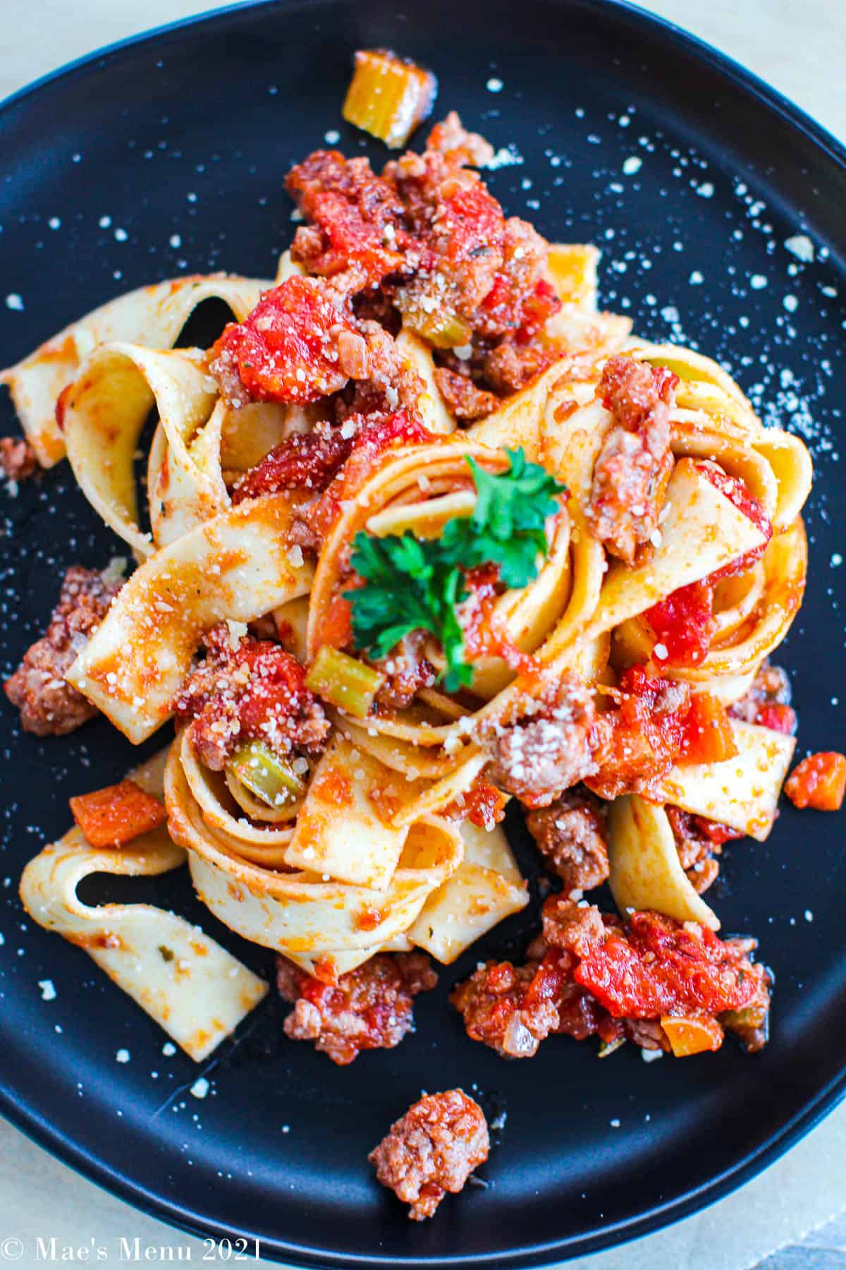 An up-close overhead shot of the bolognese sauce tossed with papparadelle