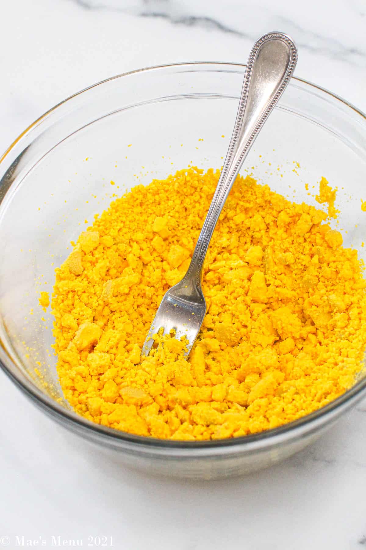 A small mixing bowl of crumbled egg yolk