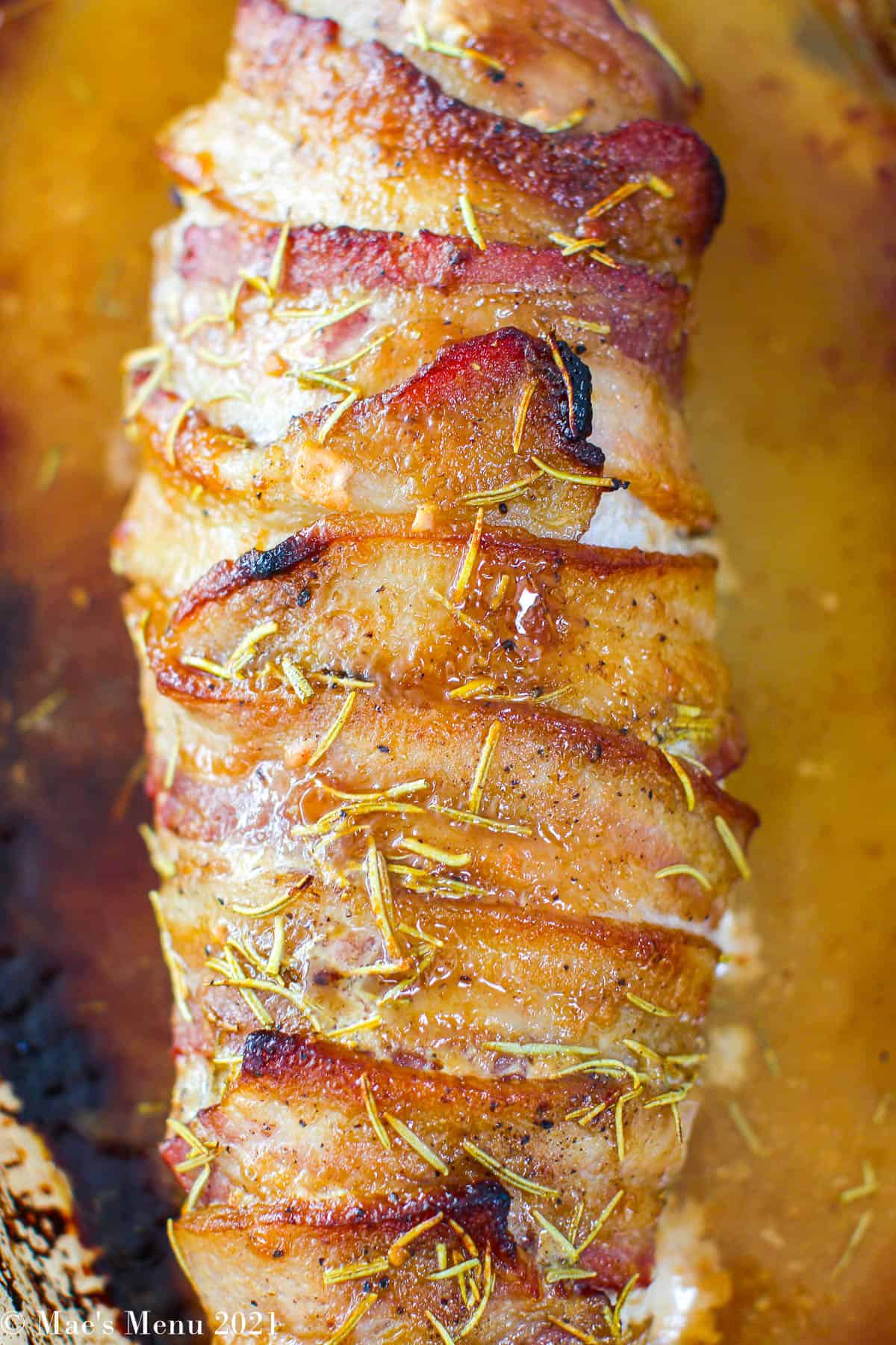 Close up overhead shot of a bacon wrapped pork tenderloin.