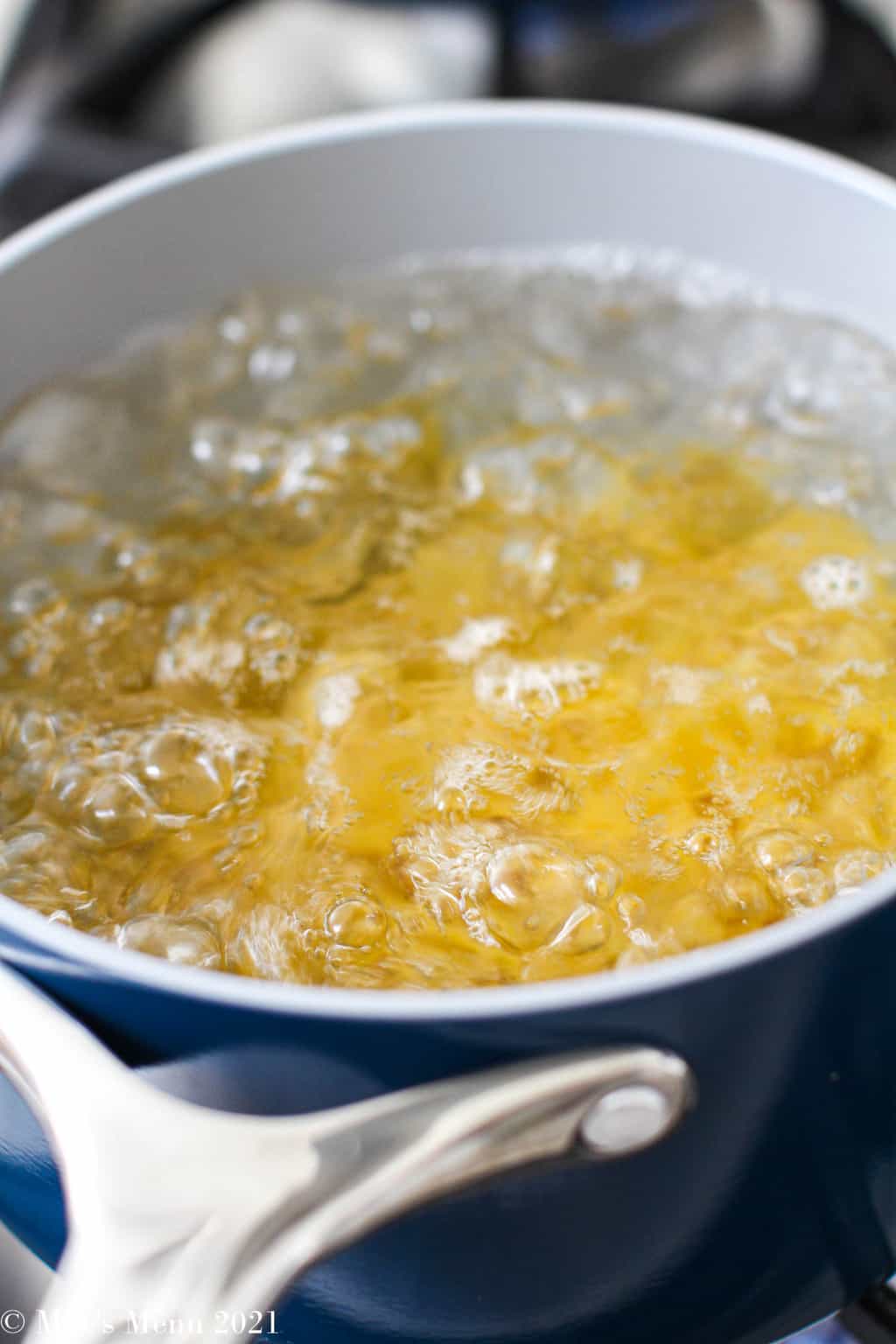 boiling the pasta in a blue saucepan