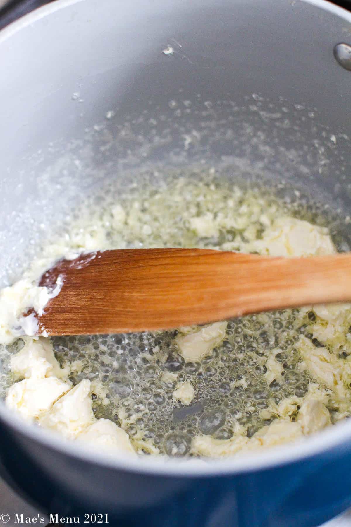 melting the butter and cream cheese in a saucepan