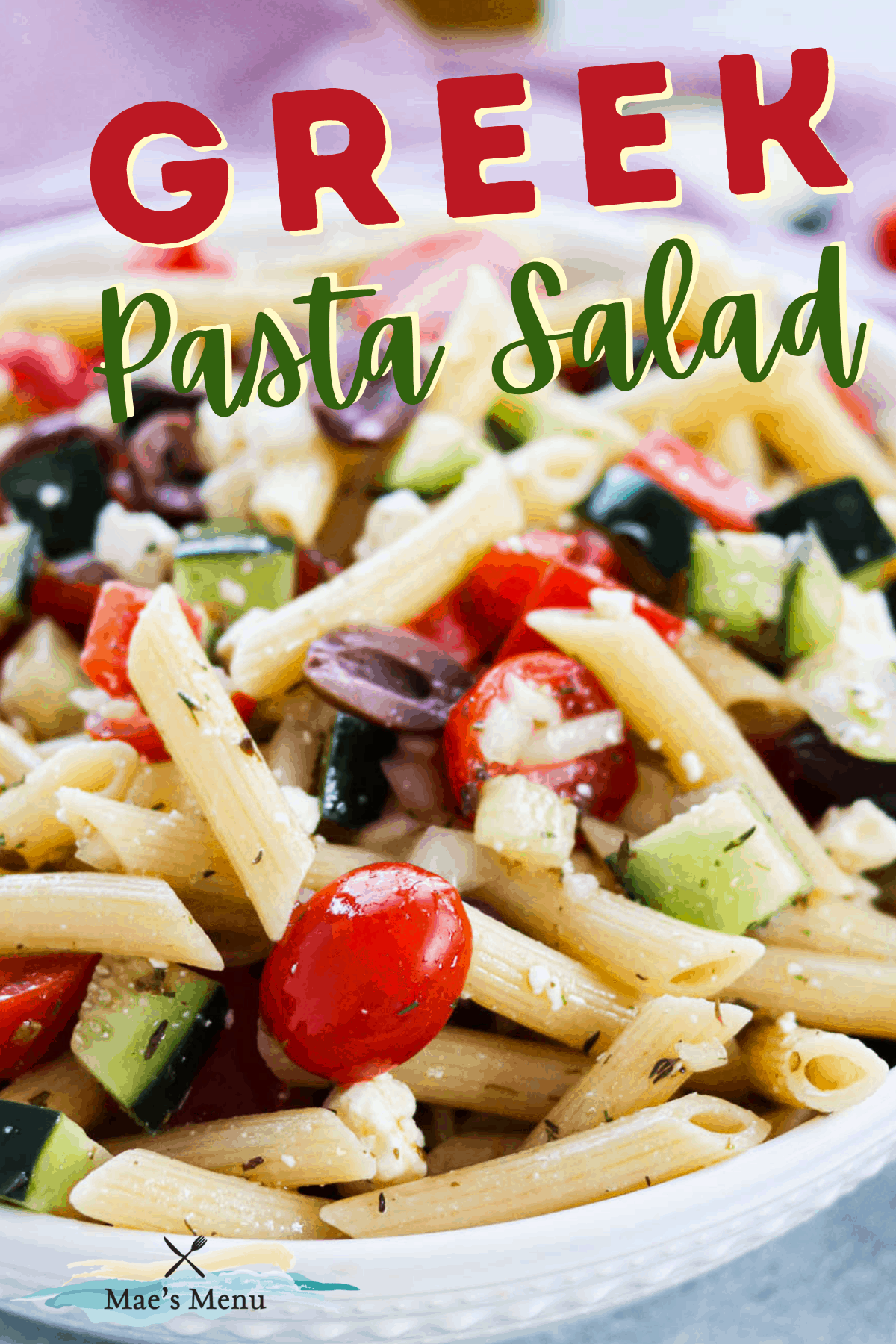 A pinterest pin for Greek pasta salad with an up-close photo of the salad in a bowl