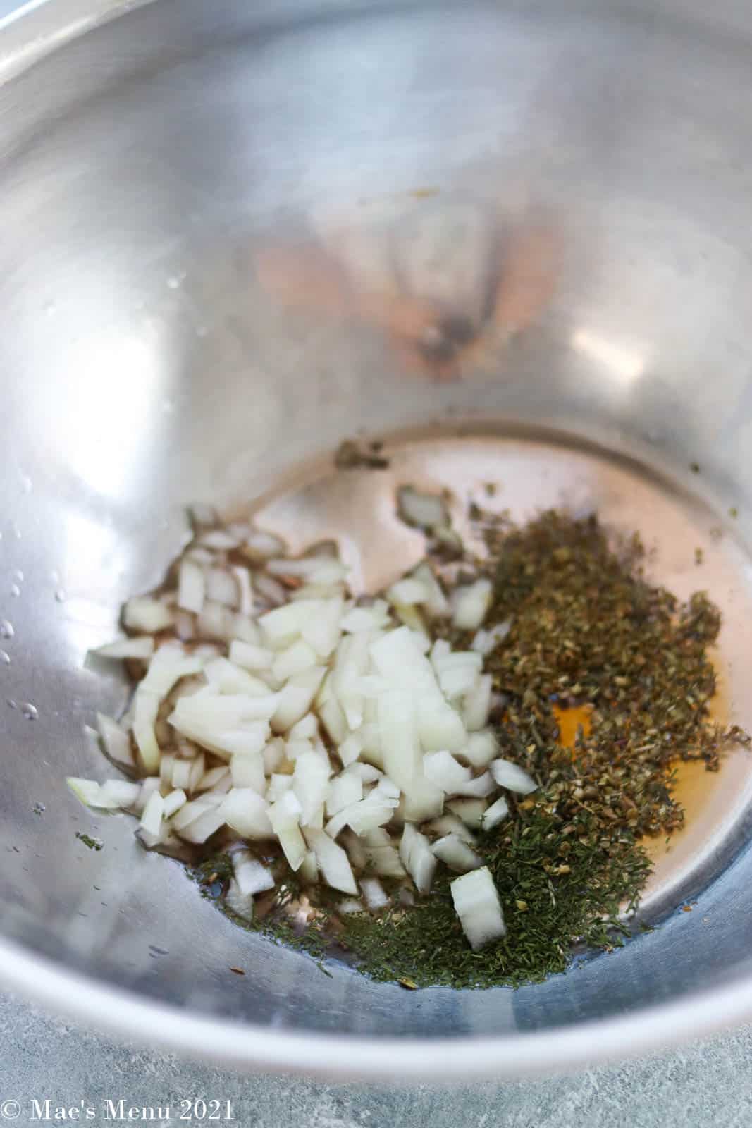 Greek cinaigrette ingredients in a mixing bowl