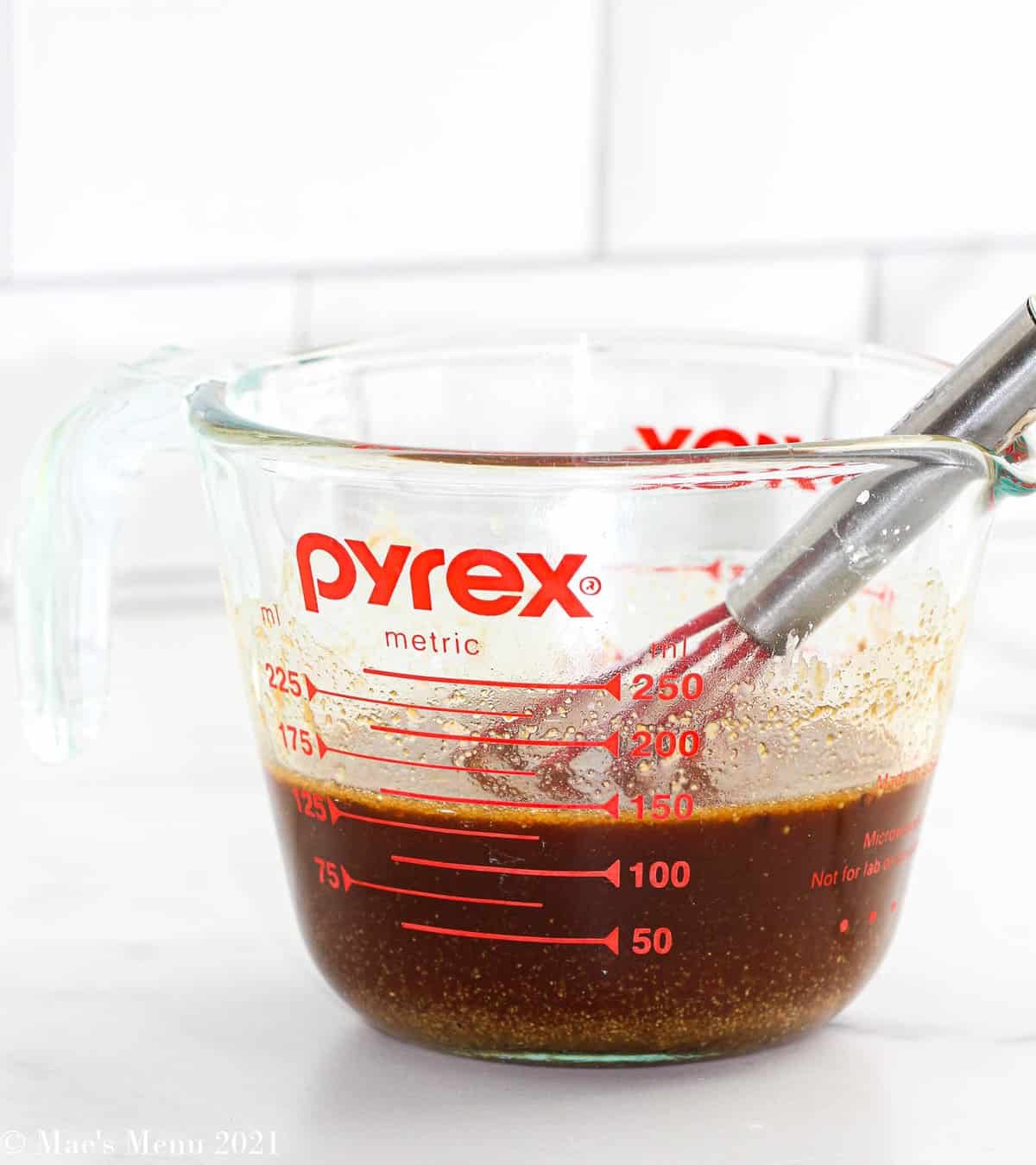 A measuring cup full of stir fry sauce