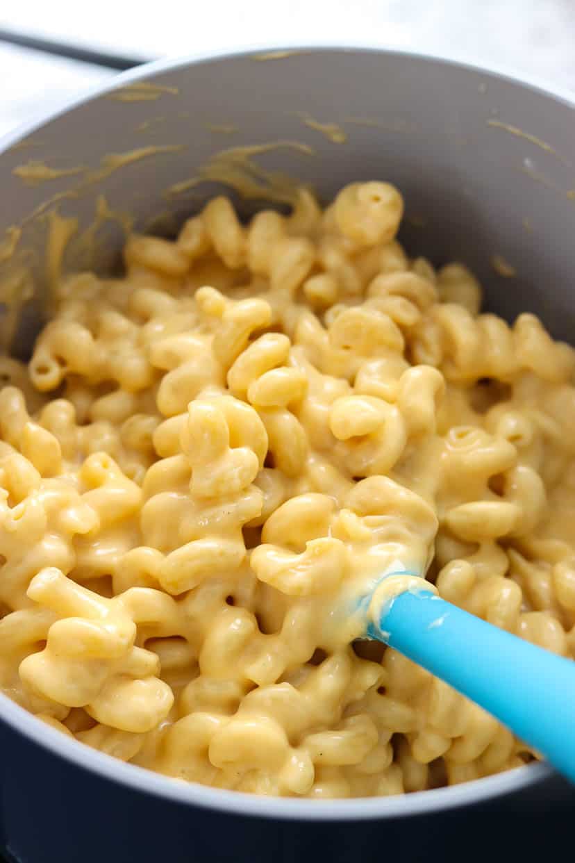large pot of homemade mac and cheese with a spatula in it