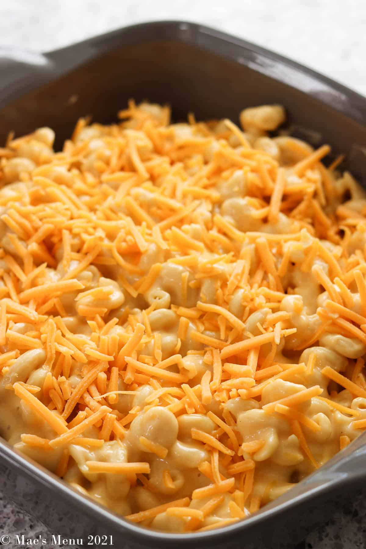 A side shot of a pan of mac and cheese before baking