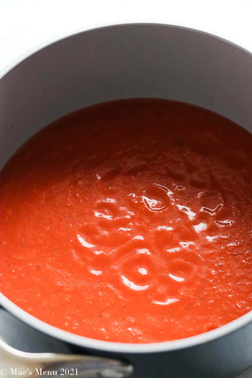 Marinara sauce in a saucepan before simmering