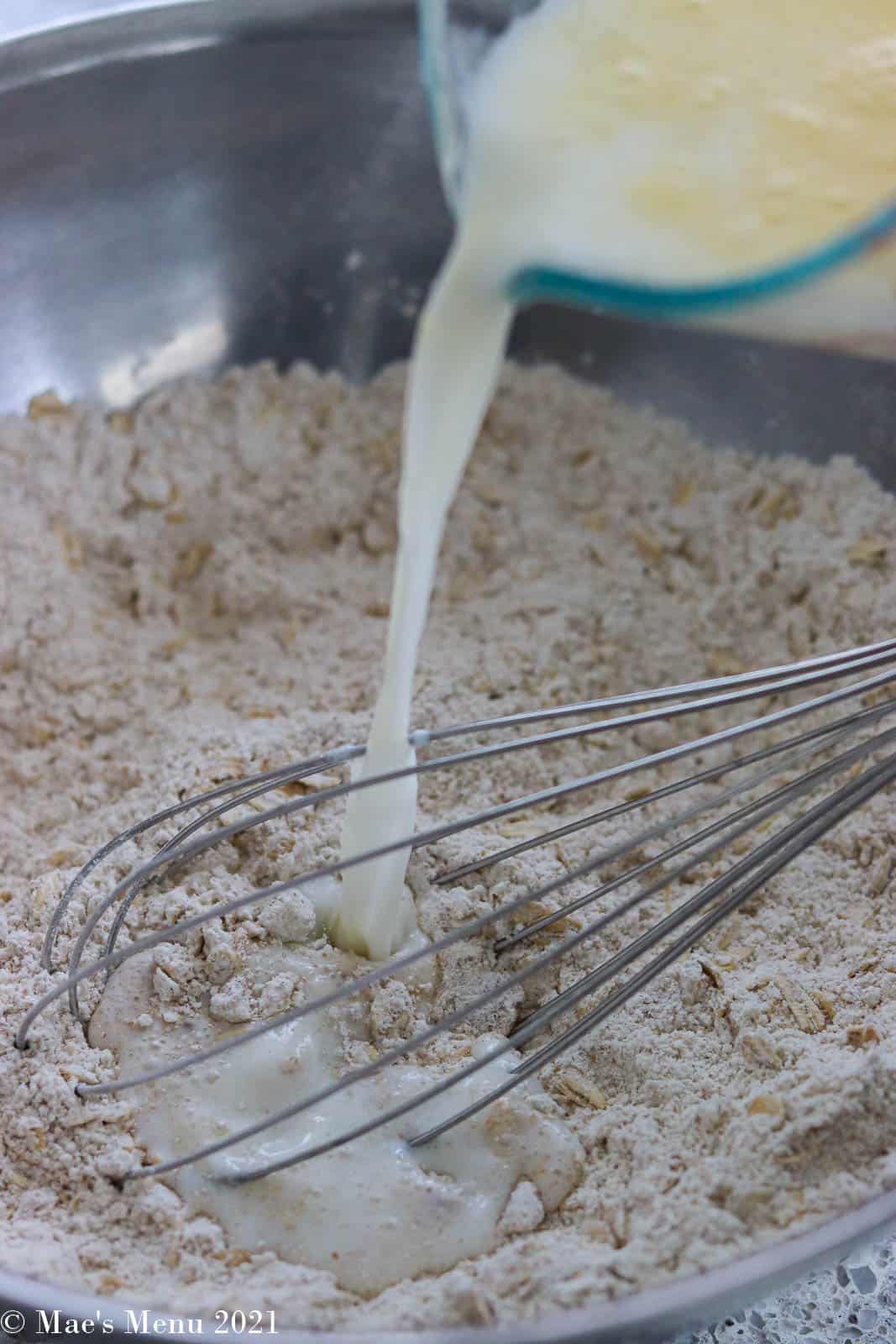 Pouring milk into the dry ingredients