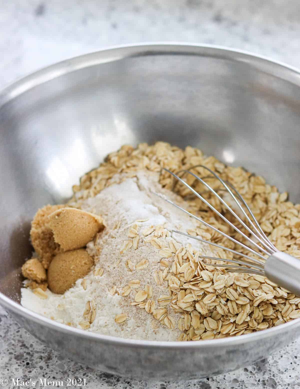 The dry ingredients for the oatmeal bread in a large mixing bowl