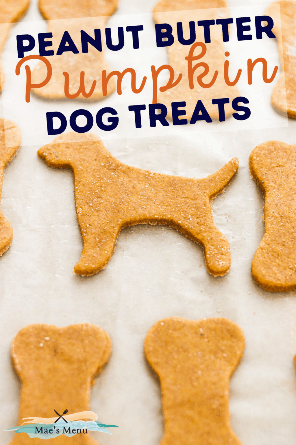 A pinterest pin for peanut butter pumpkin dog treats with an up-close shot of the un-baked treats on a baking pan 