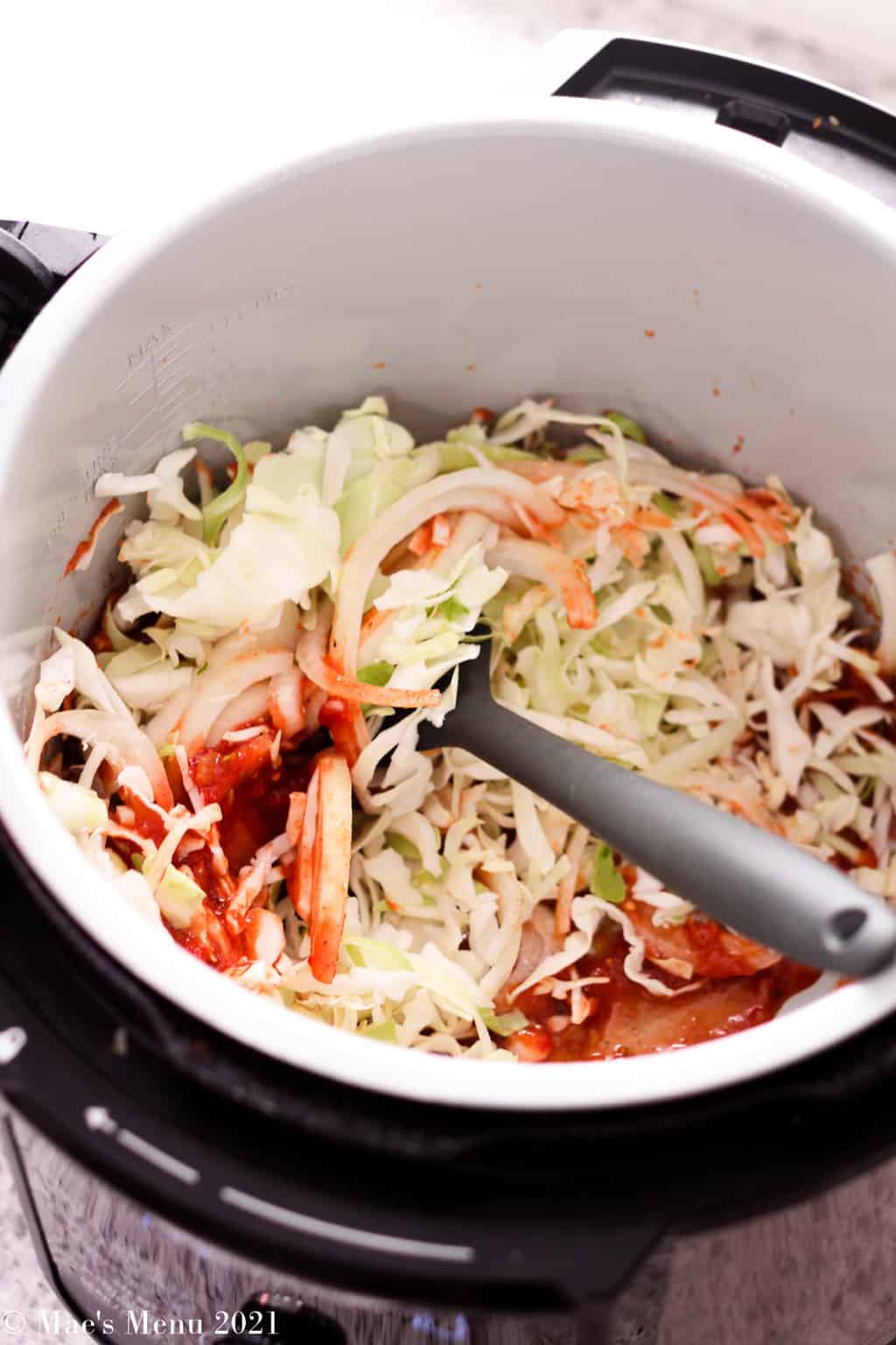 stirring shredded cabbage into the salsa mix