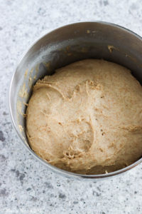 a bowl of risen naan dough.
