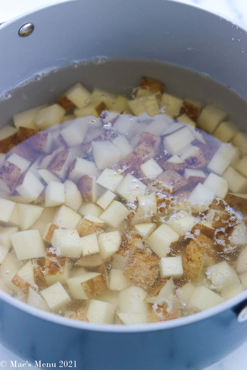 Cubed potatoes in water in a stockpot