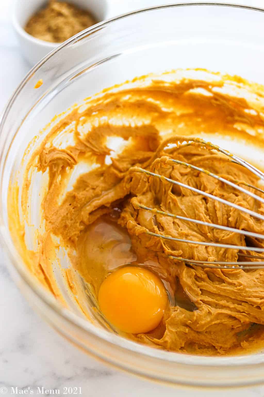 An egg in with the peanut butter and pumpkin mixture