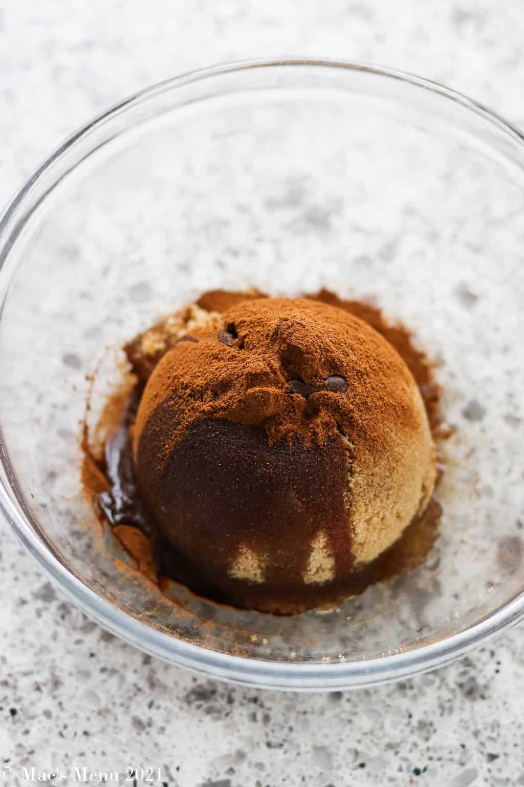 A ball of brown sugar with cinnamon and oil on top