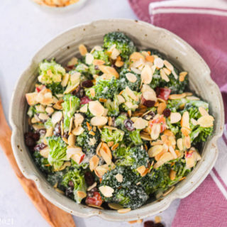 An overhead shot of a bowl of broccoli raisin salad