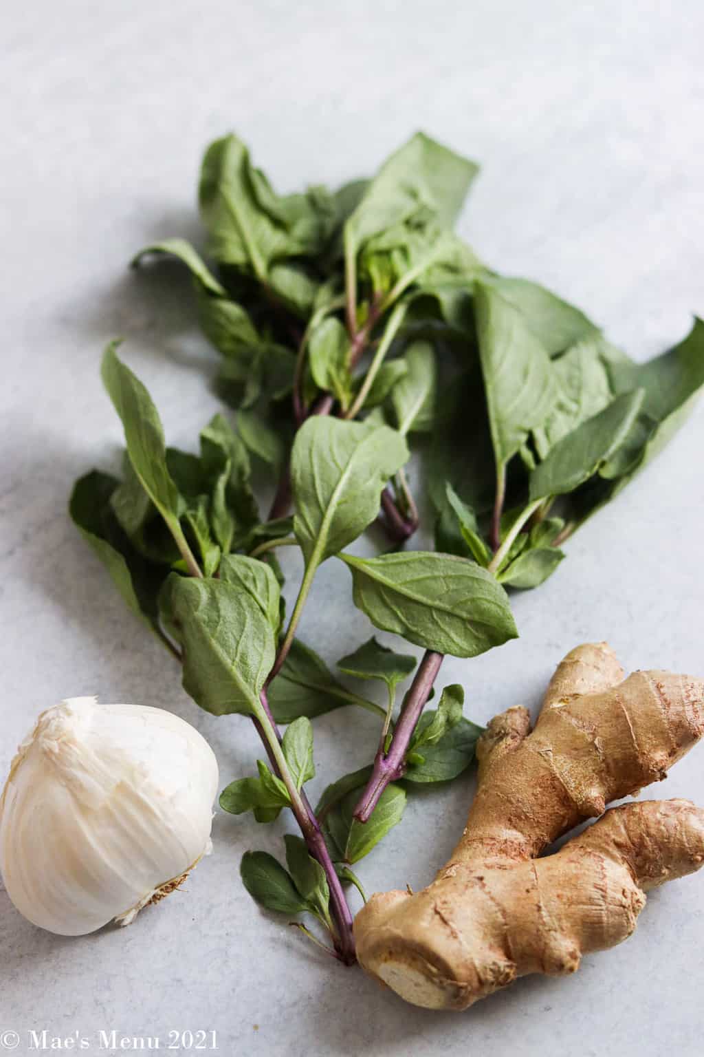 Thai basil, garlic, and ginger on the counter