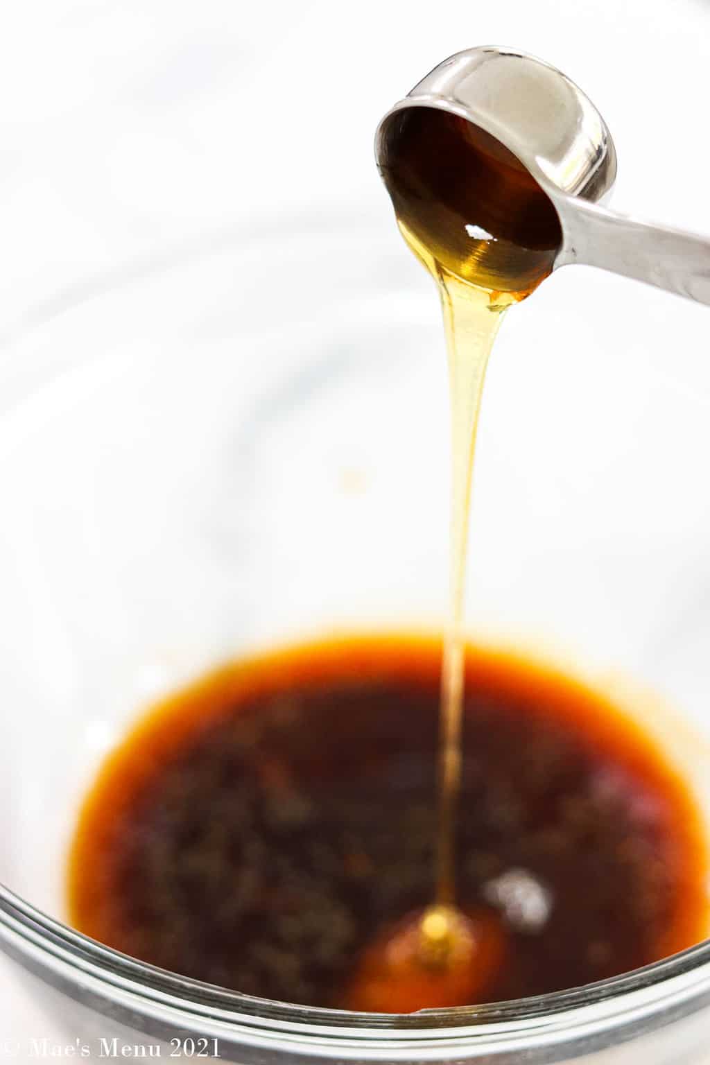 Pouring honey into the Asian chicken marinade