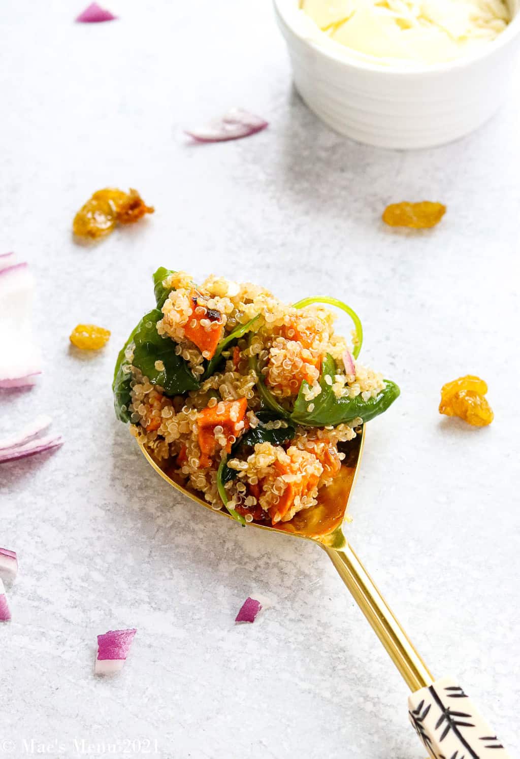 A large spoonful of sweet potato quinoa salad on the counter