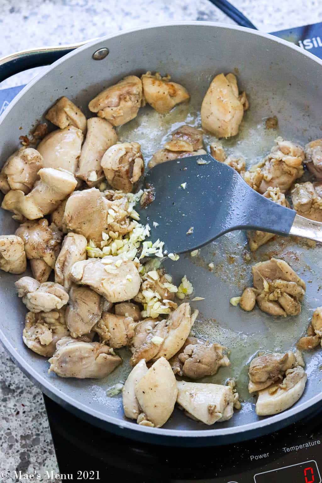chicken thigh pieces and minced garlic in a saute pan