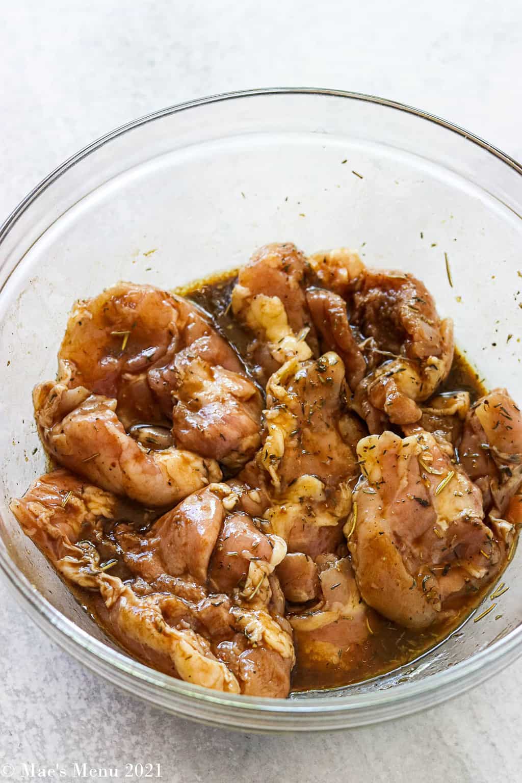 Chicken tossed in the balsamic marinade in a mixing bowl