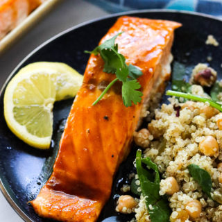 A fillet of bourbon salmon on a blue plate with quinoa salad