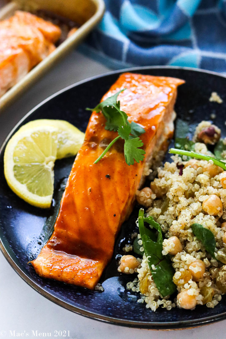 A fillet of bourbon salmon on a blue plate with quinoa salad