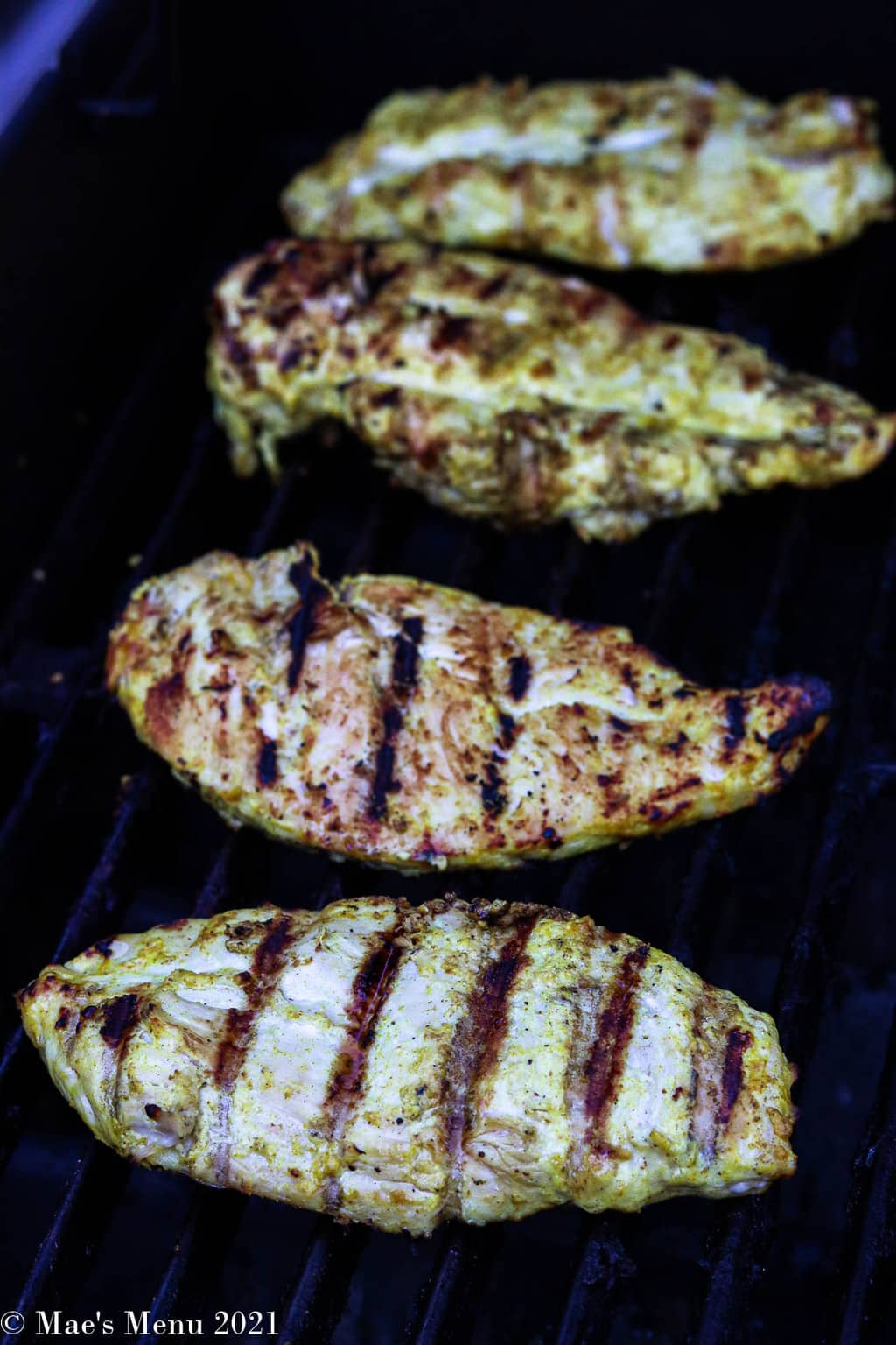 Grilled chicken breasts on a grill