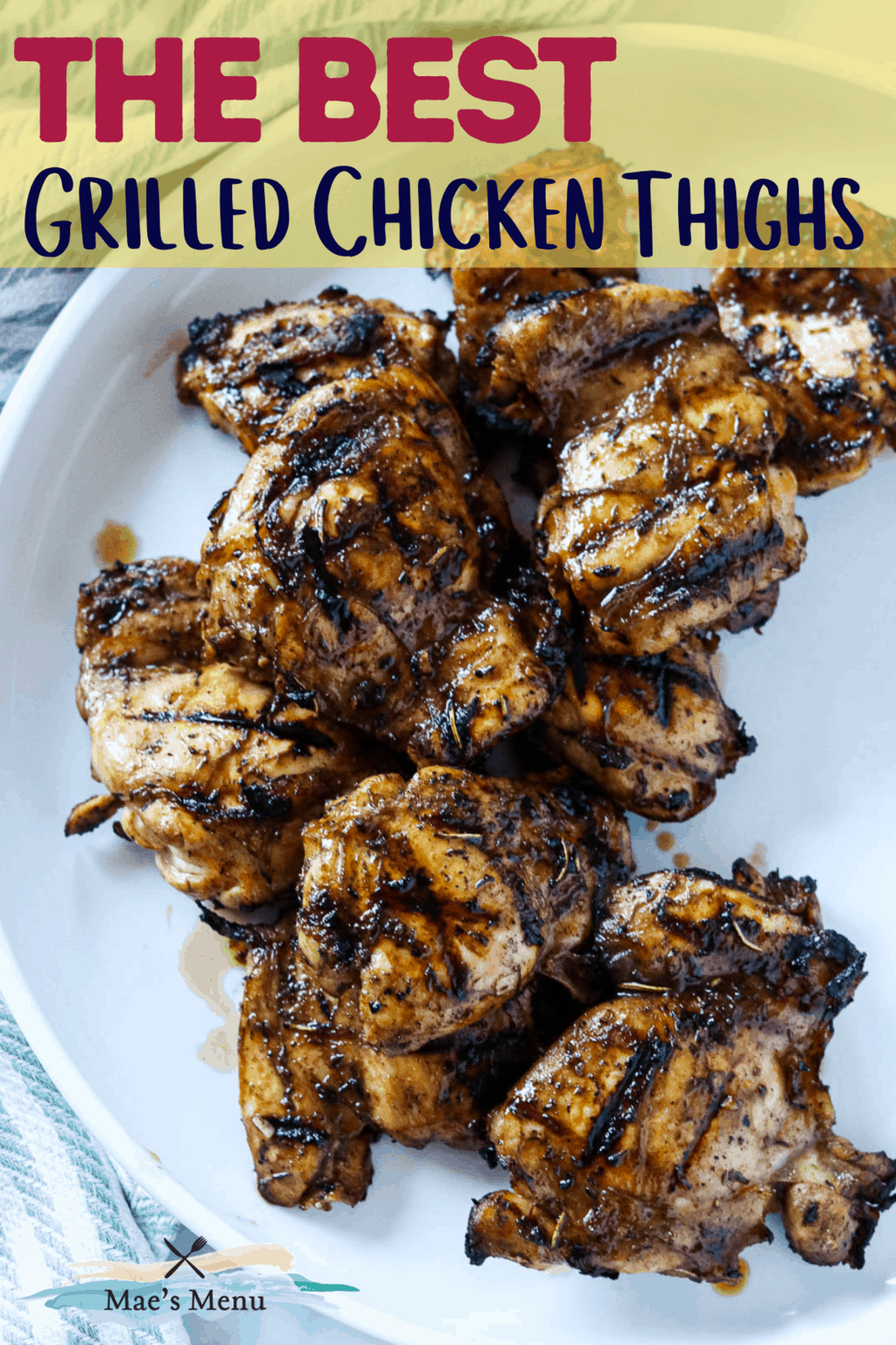 An pinterest pin for the best grilled chicken thighs with an overhead shot of the chicken on a white platter 
