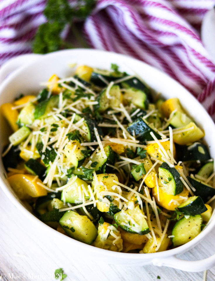 A side angle shot of a bowl of sauteed zucchini and yellow squash