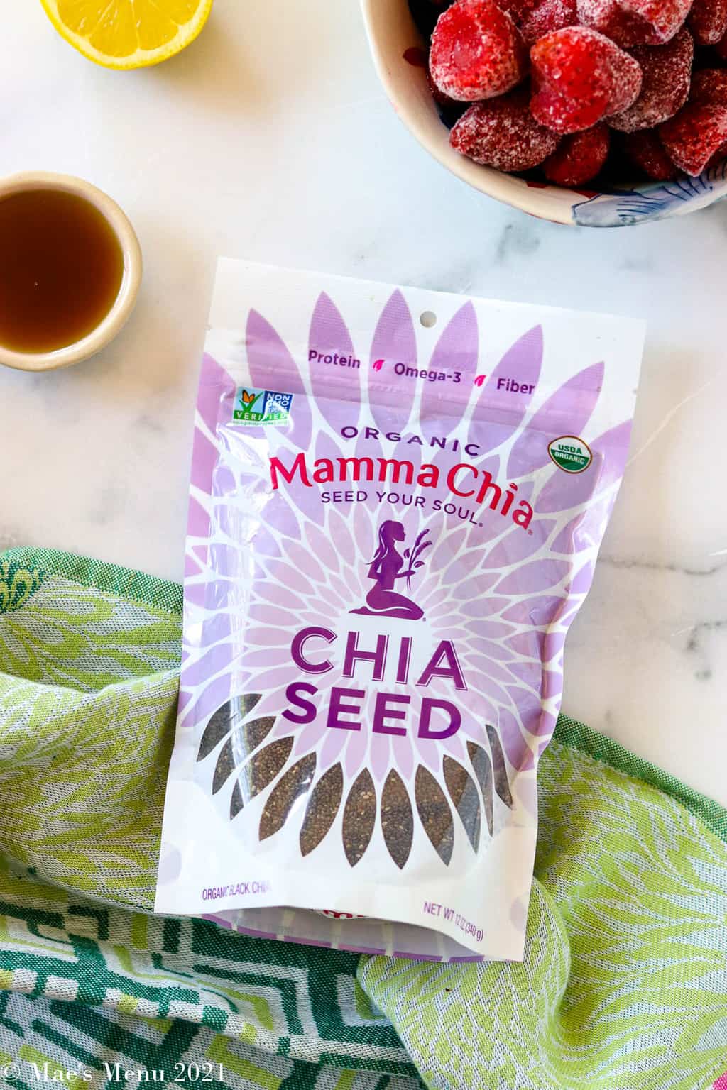 a bag of mamma chia surrounded by strawberries, maple and lemon