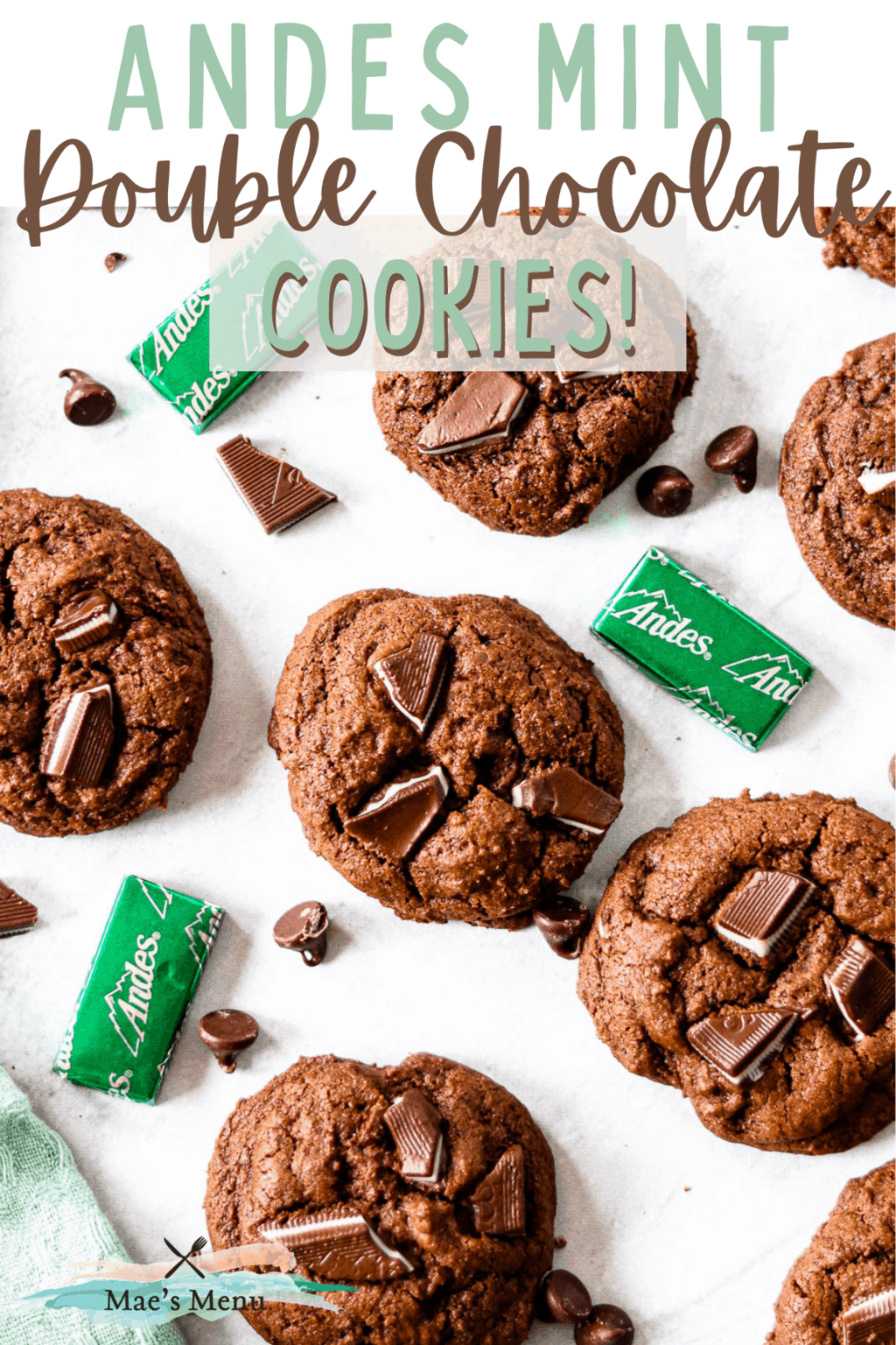 A pinterest pin for andes mint double chocolate cookies with an overhead shot of the cookies on the counter with chocolate chips and andes mints 