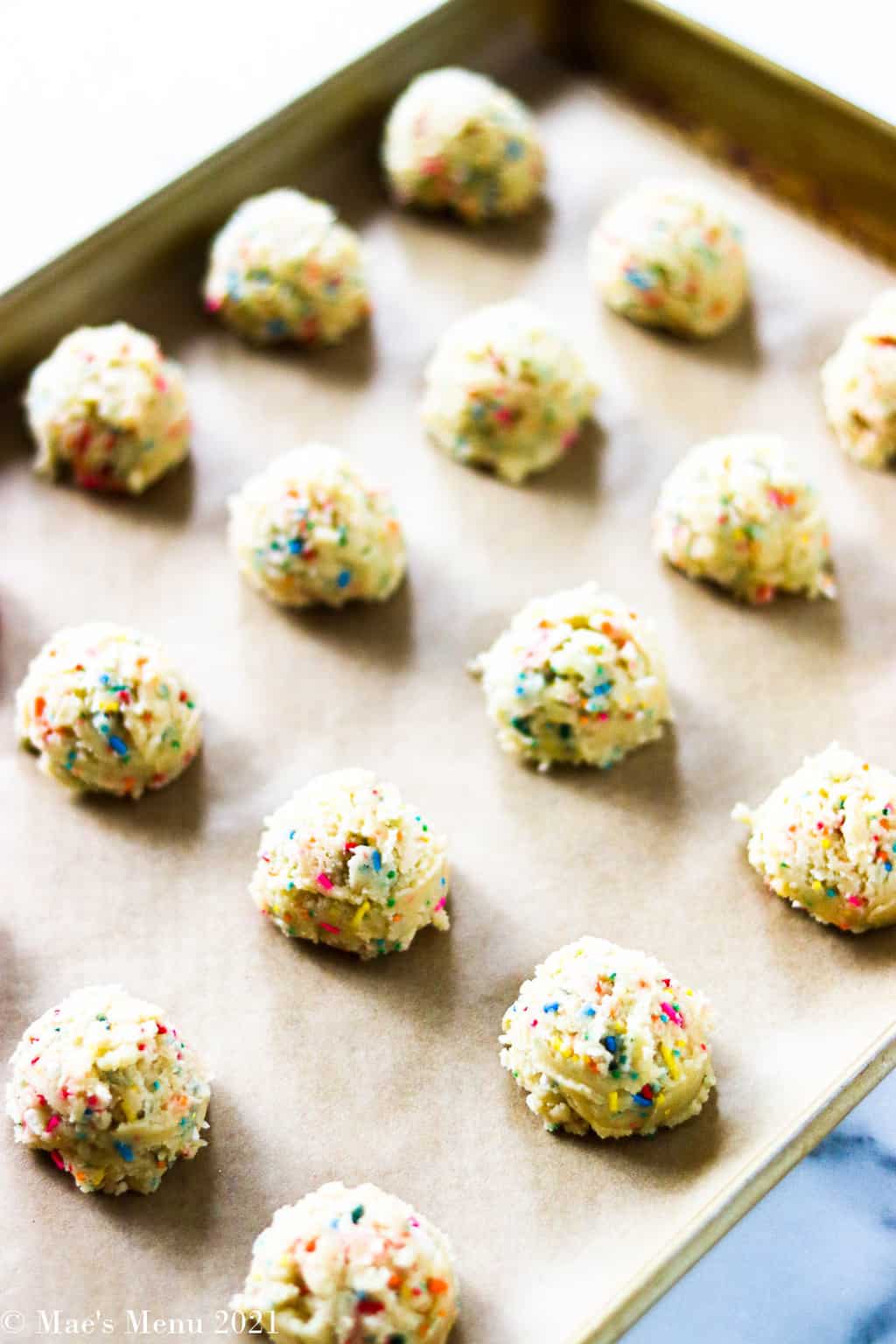 Confetti cake mix cookies scooped out onto a baking dish