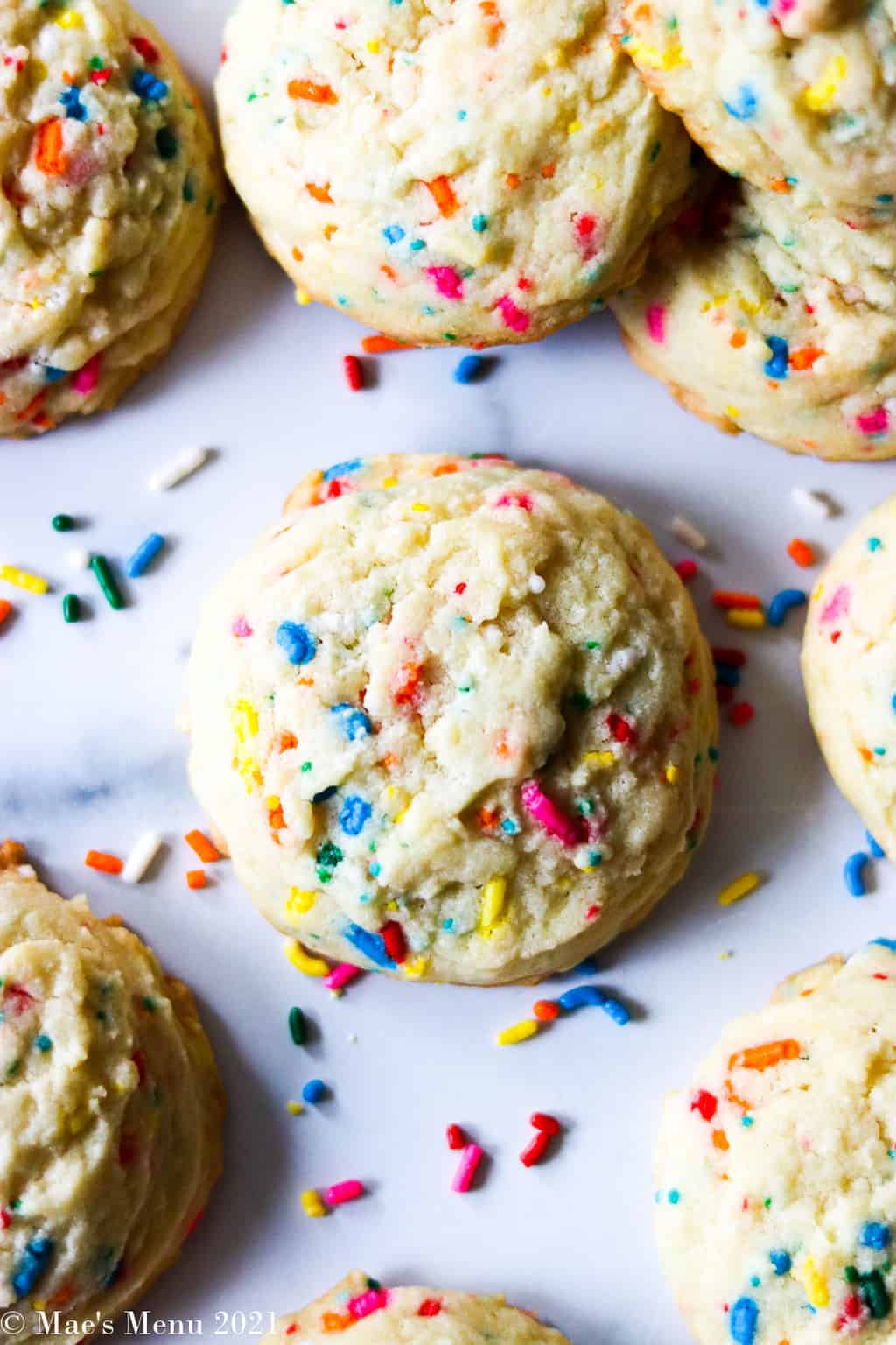 An u;-close shot of confetti cake mix cookies on a counter with sprinkles