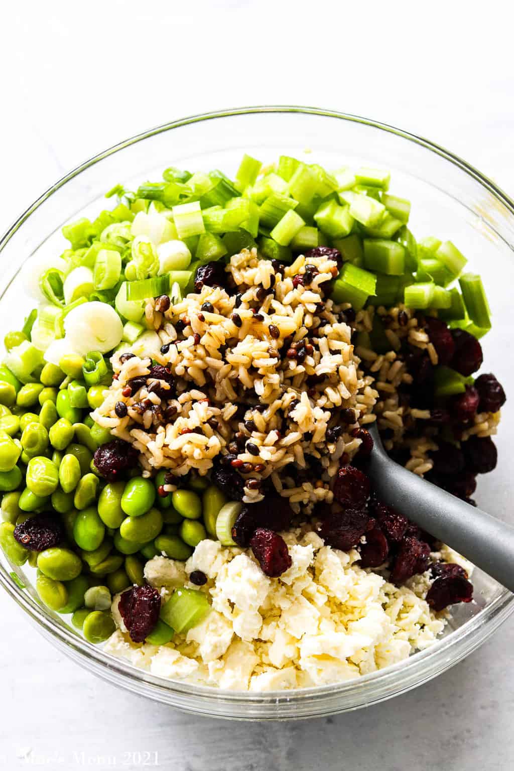Mixing the cranberry and edamame brown rice salad