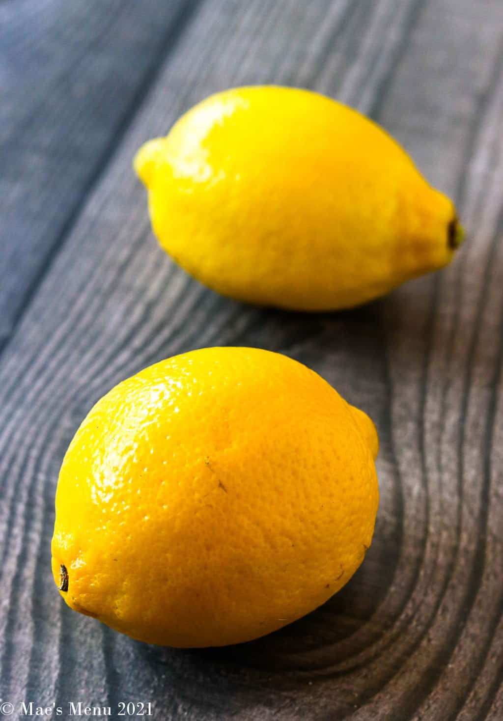 Two lemons on a piece of wood
