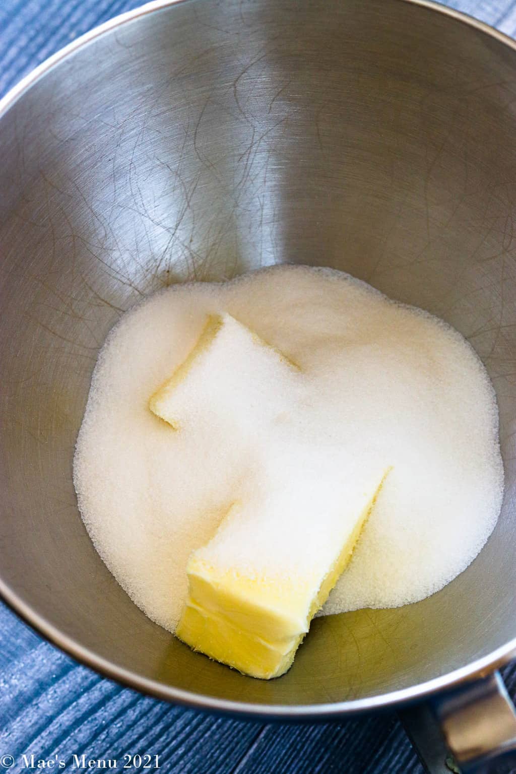 A mixing bowl of granulated sugar and butter