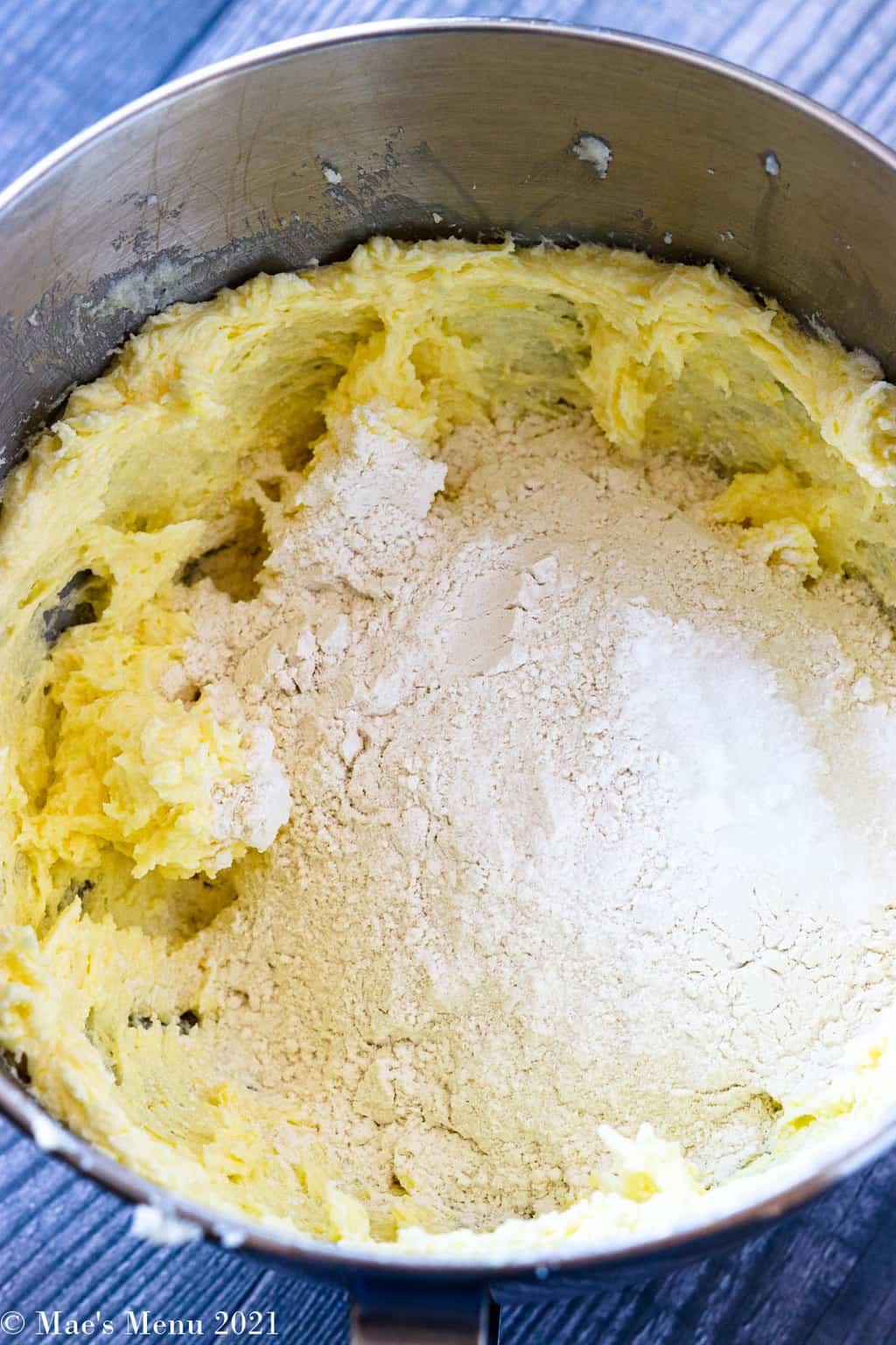 A mizing bowl of creamed butter, flour, and baking soda