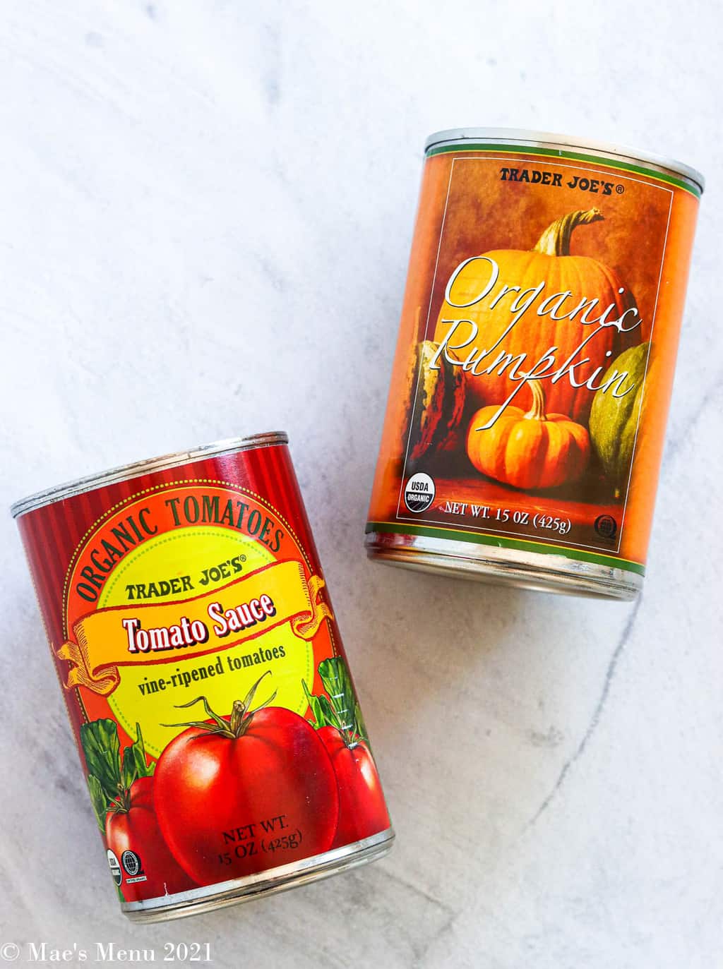 a can of tomato sauce and a can of pumpkin puree