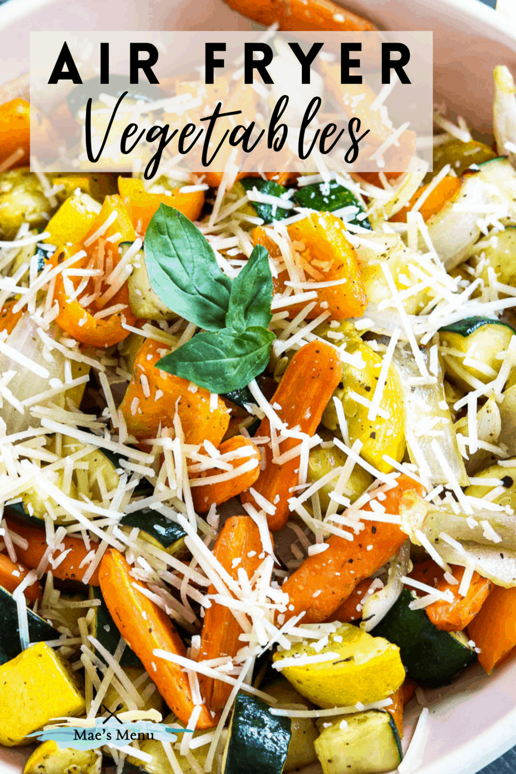 A pinterest pin for air fryer vegetables with an up-close shot of the veggies in a serving bowl 