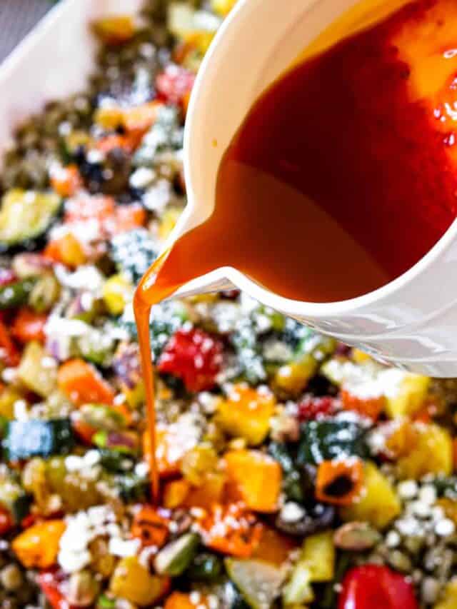 Drizzling harissa salad dressing over the Moroccan roasted vegetable salad dressing