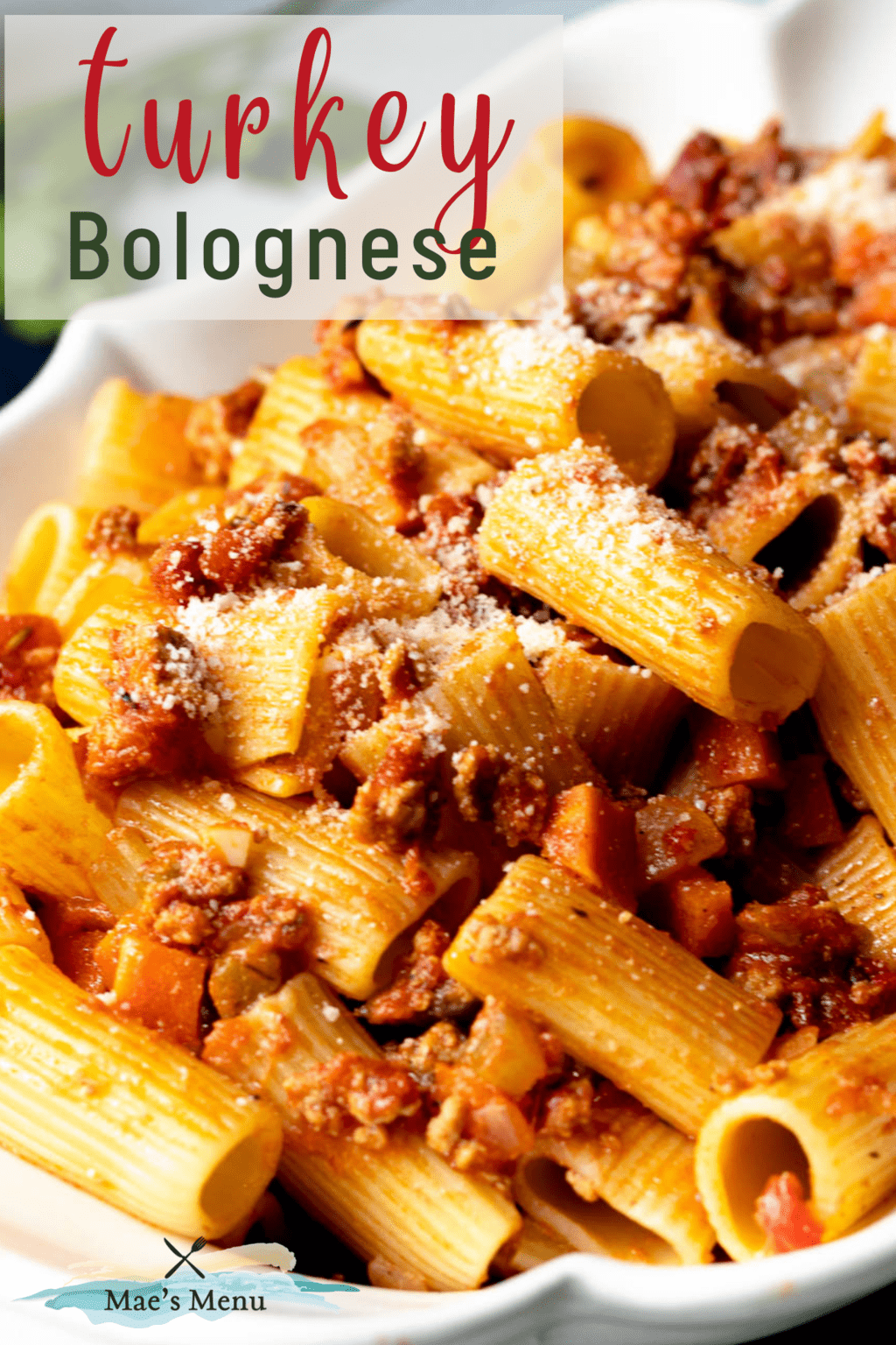 A pinterest pin for turkey bolognese with an up-close shot of pasta in the sauce in a serving bowl. 