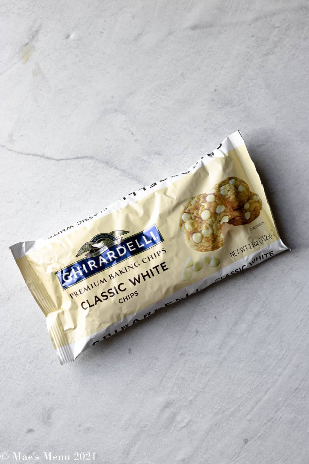 An overhead shot of a bag of ghiradelli white chocolate baking chips