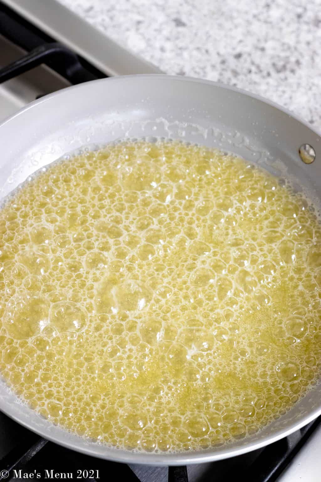 Melted butter cooking and foaming in a large skillet