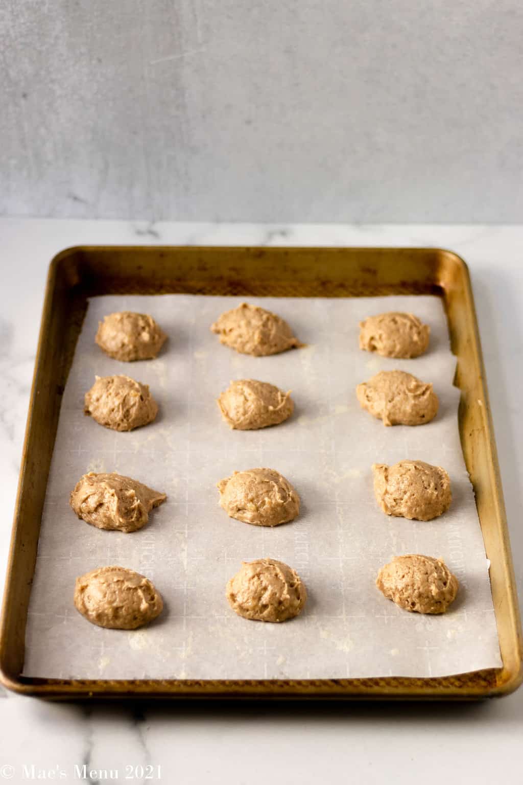 A baking sheet with scoops of banana bread cookies