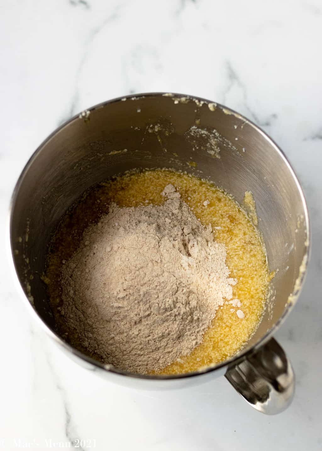 An overhead shot of a mixing bowl of the mashed banana mixture and flour