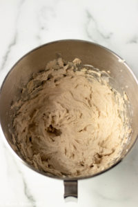 An overhead shot of a mixing bowl of maple cinnamon frosting