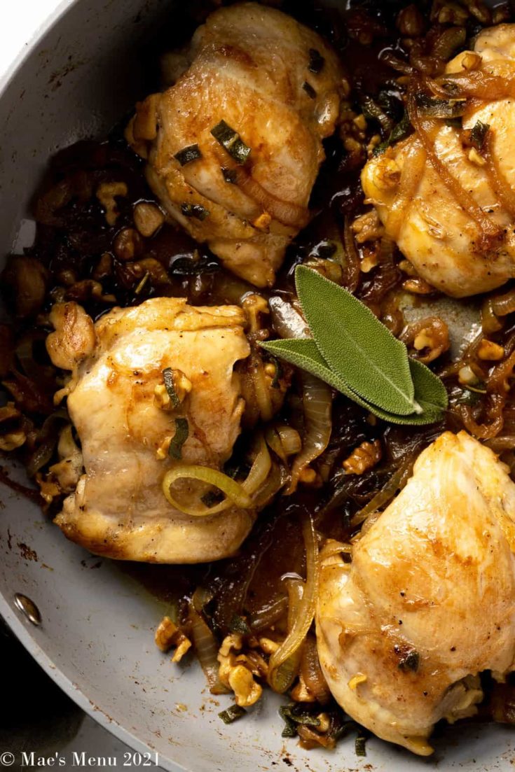 An up-close overhead shot of a pan of chicken with brown butter sauce